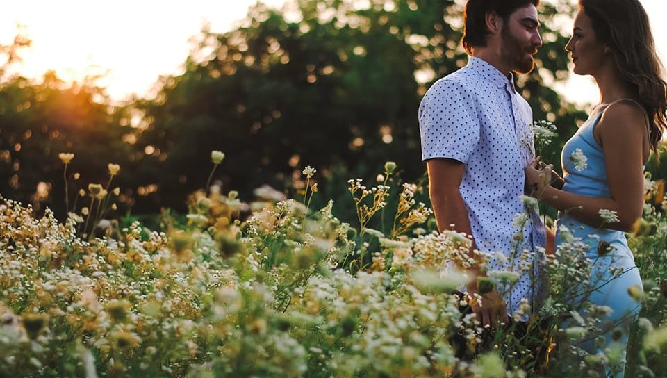 Couple walking through wildflowers as the sun sets over the Lowcountry